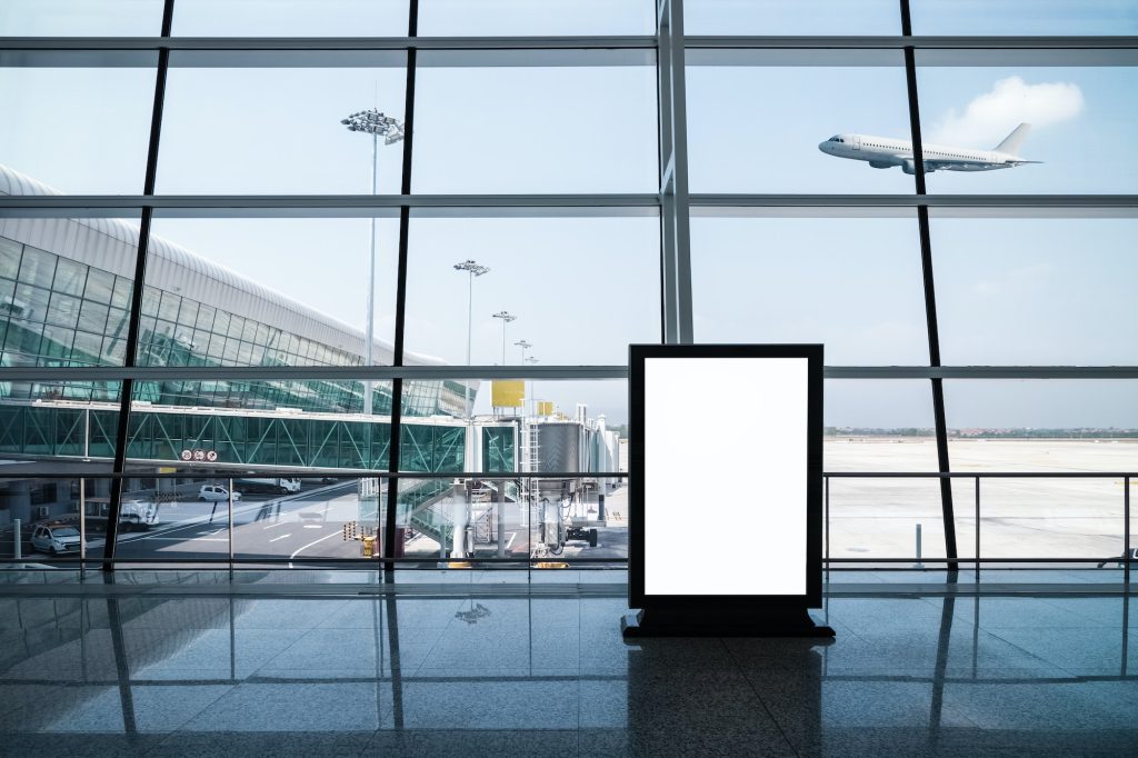 blank advertising light box on modern airport terminal